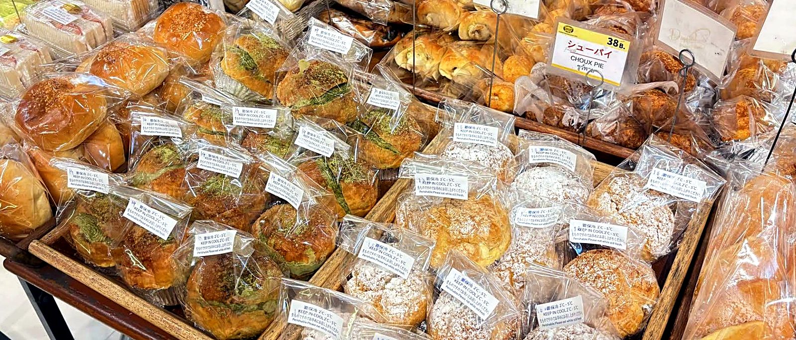 Wrapped pastries lined up for the lunch rush — Custard Nakamura, Japanese bakery Bangkok